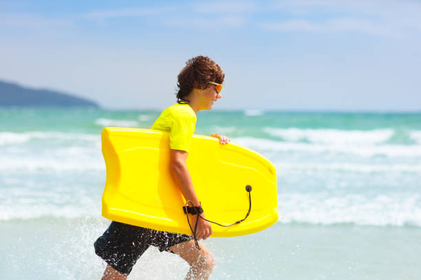 istock Surfer on tropical beach. Boy surfing. 1681207427
