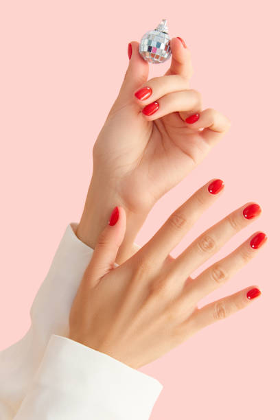 istock Womans hands with red manicure on pink background. Minimalist nail design 1681218992