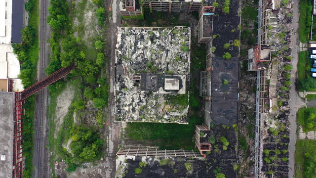 Aerial view above abandoned buildings in cloudy USA - top down, drone shot