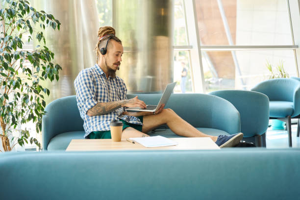 istock Informal IT specialist settled down with work on cozy sofa 1681223786