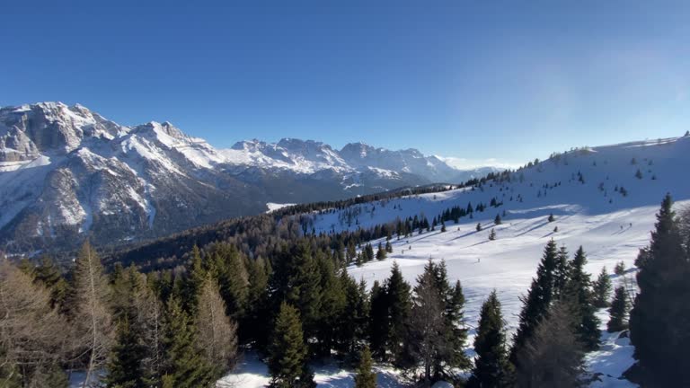 Panoramic view over ski slopes and snowcapped mountains in Dolomites