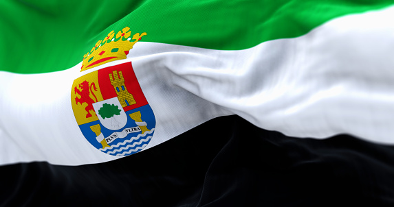 Close-up of the Extremadura flag waving. Spanish autonomous community. Green, white, and black stripes and coat of arms to the left of the center. 3d illustration render. Rippled fabric background