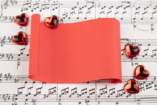 Hearts  and red paper on musical score