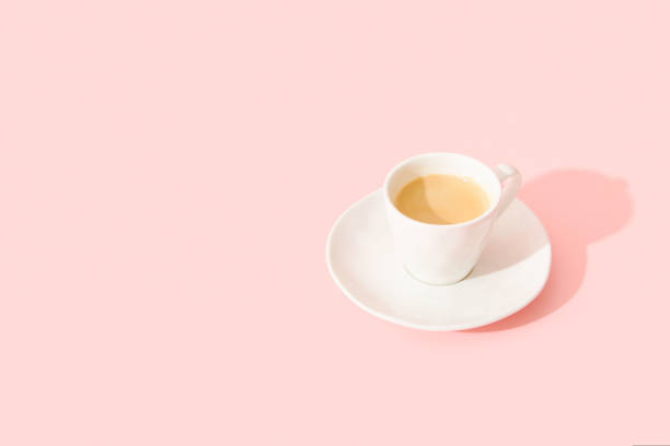 istock Espresso coffee on pastel pink background with long shadow 1681326358