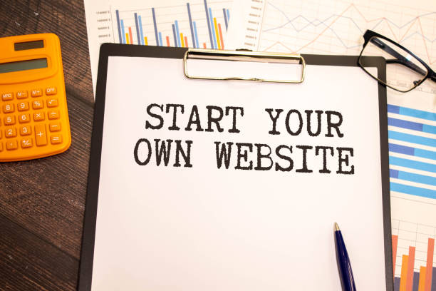 istock Notebook with text START YOUR OWN WEBSITE on wooden table with pen, magnifier and glasses 1681356429