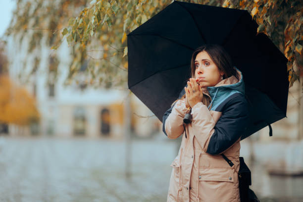 istock Woman Rubbing Hands Feeling Cold in a rainy Day 1681361186