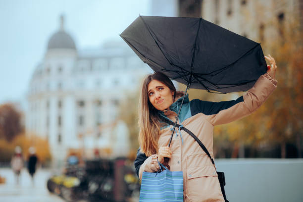 istock Stressed Woman Walking in the Rain with Broken Umbrella 1681361187