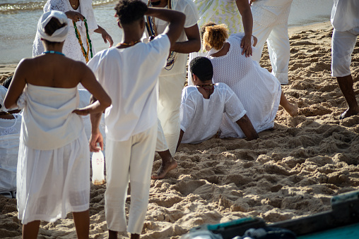 Salvador, Bahia, Brazil - December 12, 2021: members of the Candomble religion are seen gathered on Rio Vermelho beach in the city of Salvador, Bahia.