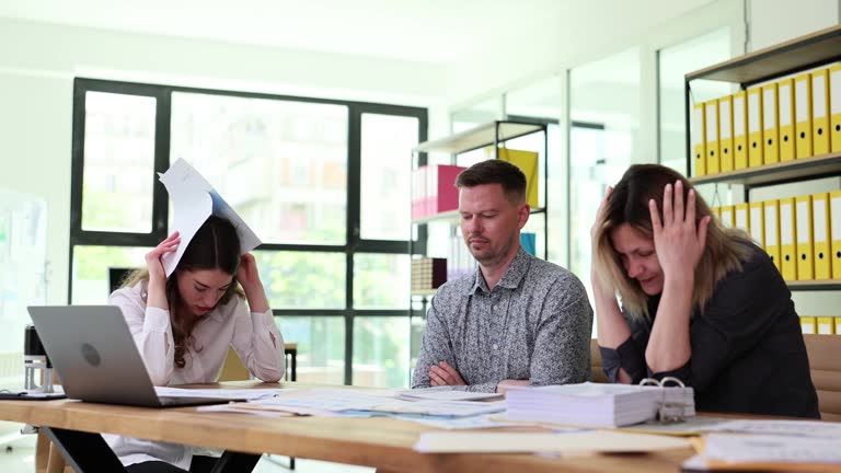 Business team has meeting in office and solves problem