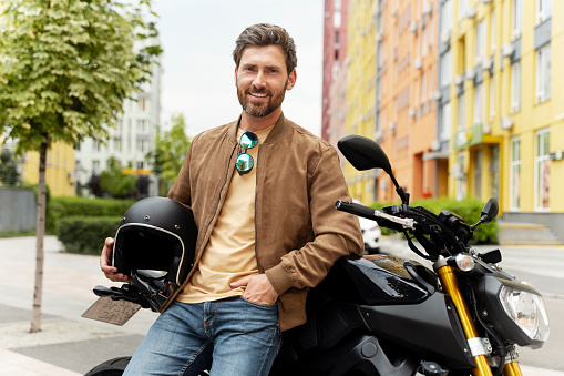 African American Man riding motorcycle on late summer/early fall evening