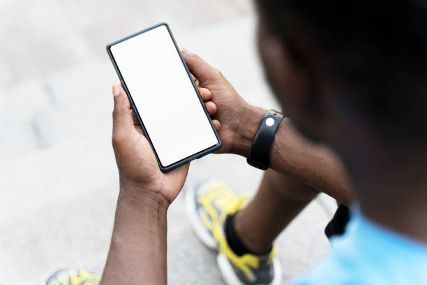Cropped view young african american man holding mobile phone, watching video