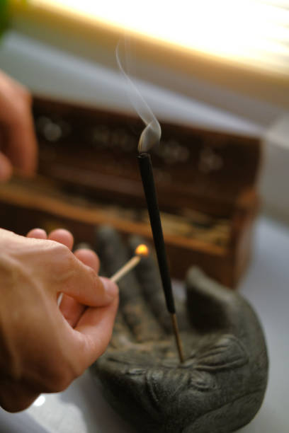 istock A match in the palms ignites an incense stick 1681486703