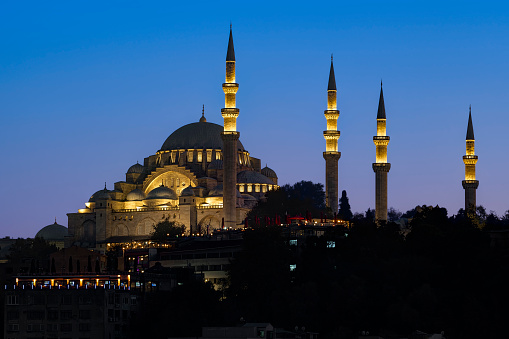 Suleymaniye Mosque (Süleymaniye Camii) at sunset.  View from Golden Horn Metro Bridge. Istanbul, Turkey.