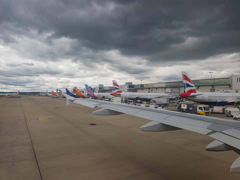 Crawley, Sussex, UK - 27th August 2023: A row of aircraft parked at Gatwick Airport in Sussex, UK