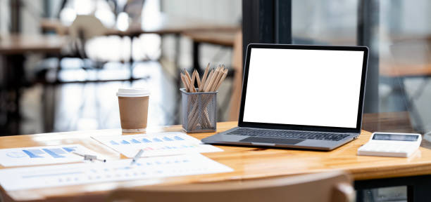istock Mockup blank screen laptop computer on wooden table. 1681561332