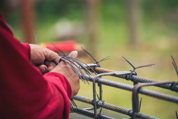 istock Men hands using pincer pliers iron wire reinforcement of concrete work. Construction Worker hands bending cutting steel wire fences bar. Outdoor Worker using wire bending pliers, construction work. 1681578975