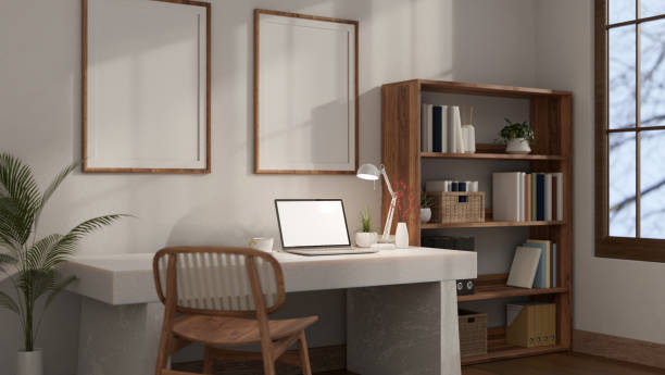 istock Minimalist white home office workplace with a laptop mockup on a white table against the white wall. 1681587064