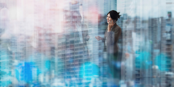 Double exposure of confidence young businesswoman over city scape.