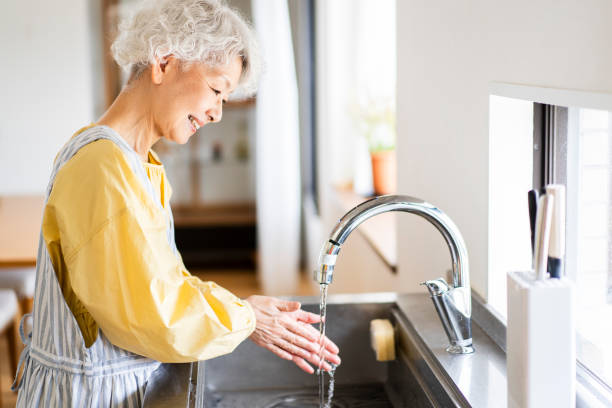 istock A senior woman is washing her hands. 1681641854