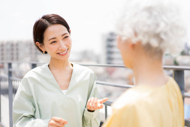 istock Two women standing outside and talking. 1681644473