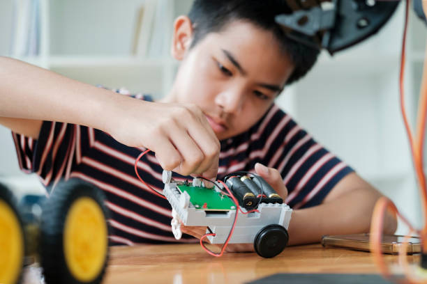 istock Asian teenager doing robot project in science classroom. technology of robotics programing and STEM education concept. 1681716431
