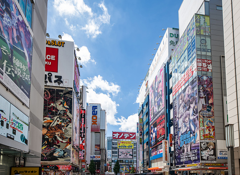A street scene in Akihabara, Tokyo, Japan on a slightly cloudy day. Anime billboards can be seen on the buidings
