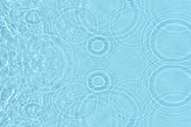 istock Blue water with ripples on the surface. Defocus blurred transparent blue colored clear calm water surface texture with splashes and bubbles. Water waves with shining pattern texture background. 1681765390
