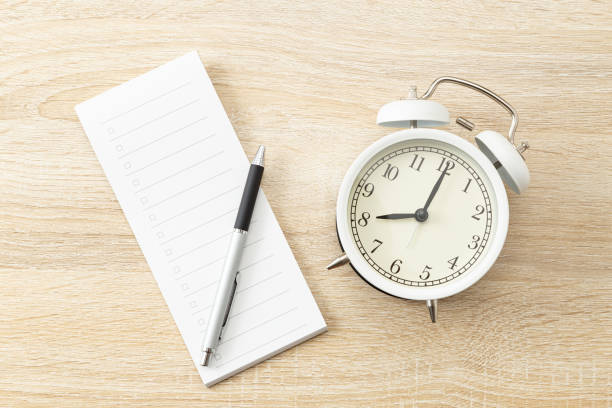 istock A checklist and a clock on the desk. 1681768611
