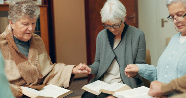 istock Praying, support and holding hands with people in bible study for worship, Christian and spiritual. Community, faith and religion with prayer group in church for connection, hope and meeting together 1681769420