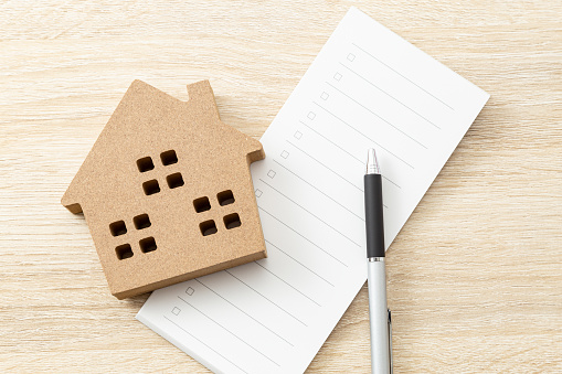 A checklist and household objects on the desk.