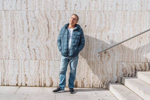 istock Portrait positive middle-aged man against background marble wall with steps 1681770578