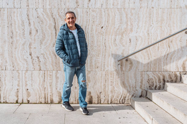 istock Portrait positive middle-aged man against background marble wall with steps 1681770872