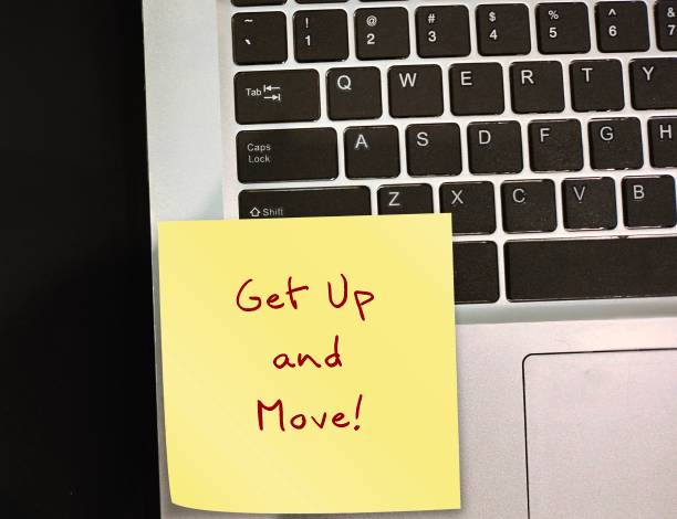 istock Reminder stick note on laptop with handwritten text Get Up and Move, to beat sedentary lifestyle and move around, avoid sitting for long periods of time 1681837334