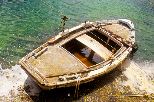 Old row fishing boat on beach, Rías Baixas, Pontevedra province, Galicia, Spain.