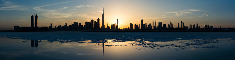 This is one in a series of photographs that capture Dubai at sunset from the newly-developed Design District in Dubai. This part of Dubai Creek has been dammed and most of the water has evaporated over time, leaving the salt deposits.