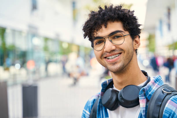 istock Smiling young attractive man with brackets wearing headphones looking at camera 1681883162