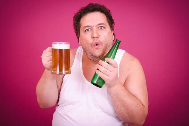 istock Funny fat man is engaged in vacation at sea drinking beer. 1681902258