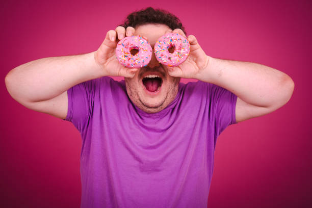 istock Funny fat man eating donuts on vacation. 1681903282