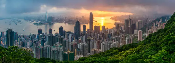 One of the luckiest collections of sunrise pictures I've taken. The cloud kept flowing over the hills behind me until the sun rose and broke-through, turning Kowloon Bay golden and bathing the city in it's light. The cloud above and forest below provide the perfect frame.