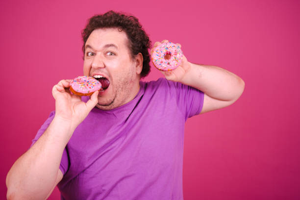 istock Funny fat man eating donuts on vacation. 1681908001