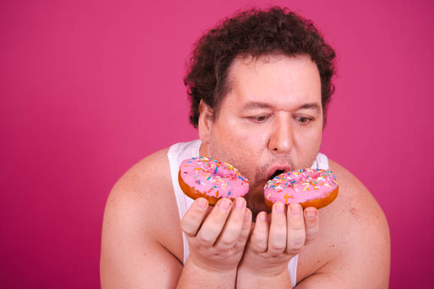istock Funny fat man eating donuts on vacation. 1681916330