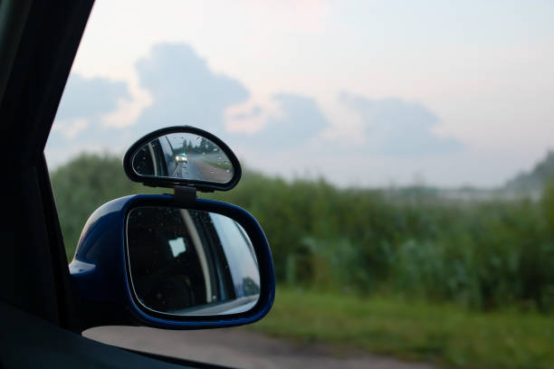 istock Side mirror of the car at sunset nature 1681924636