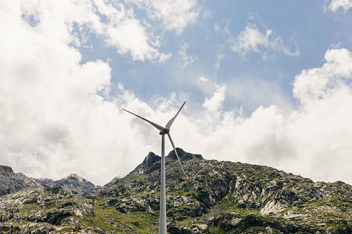 alpine wind turbines at an altitude of 2000 meters, turbines against the backdrop of mountains, ecology, wind power