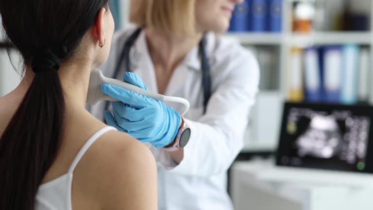 Doctor's hands with a probe on a woman's neck