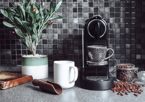 Kitchen with coffee machine,raw beans with scoop and white cup for perfect morning breakfast on black