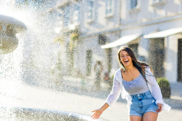 istock Woman having fun with water next to fountain 1681973186
