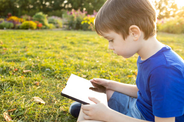 istock A 6 year old boy uses a digital tablet in a city park 1681979204