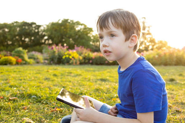 istock A 6 year old boy uses a digital tablet in a city park 1681979718