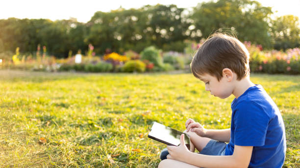 istock A 6 year old boy uses a digital tablet in a city park 1681998125