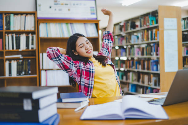 istock Students are relaxing after working on their laptops and searching for books to study, make reports, find useful information in the university room. 1682010860